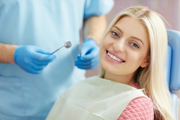 Woman sitting in dentist chair getting root canal